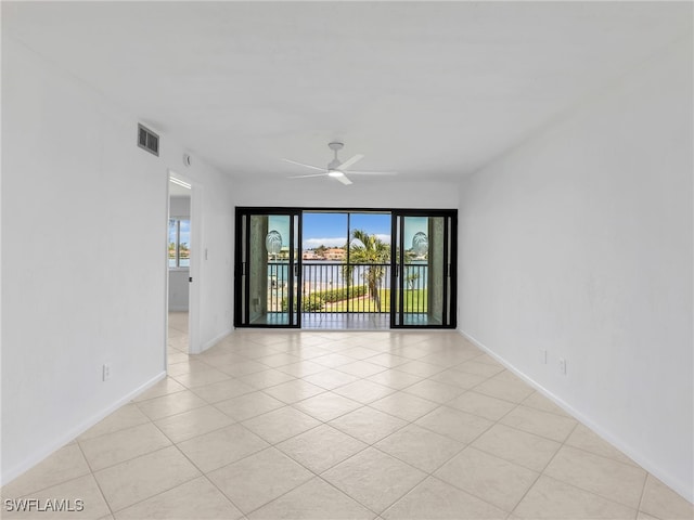 750 W Elkcam Cir Unit 312, Marco Island, FL 34145 - unfurnished room featuring a ceiling fan, light tile patterned floors, and a water view