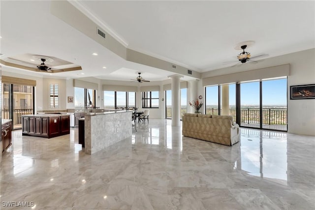 14300 Riva Del Lago Dr Unit 2103, Fort Myers, FL 33907 - unfurnished living room with a ceiling fan, healthy amount of natural light, ornate columns, crown molding, and a raised ceiling