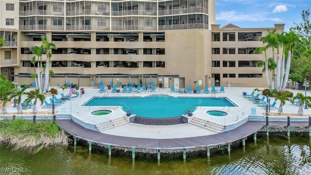 14300 Riva Del Lago Dr Unit 2103, Fort Myers, FL 33907 - community pool featuring a hot tub, a patio area, and a water view