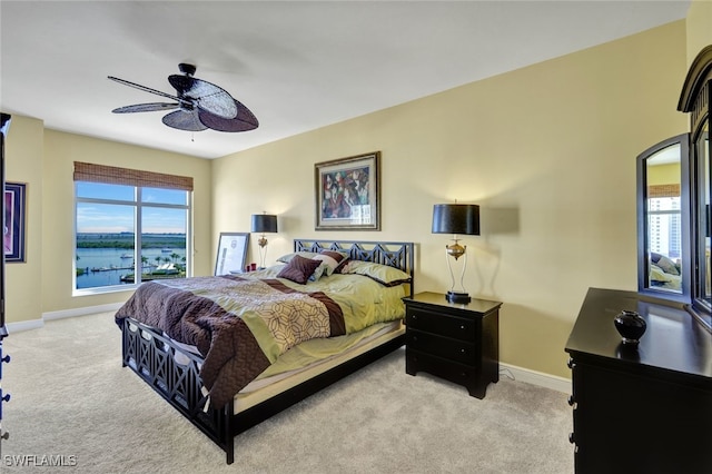 6081 Silver King Blvd Unit 704, Cape Coral, FL 33914 - carpeted bedroom featuring multiple windows, baseboards, a ceiling fan, and a water view