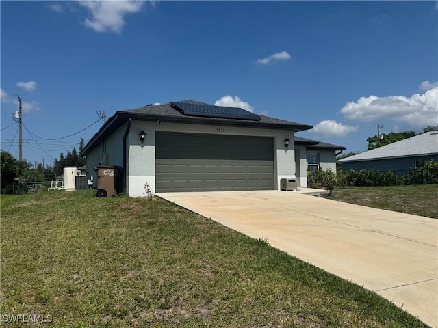 1818 NE 6th Pl, Cape Coral, FL 33909 - view of home's exterior with stucco siding, solar panels, a garage, and a yard