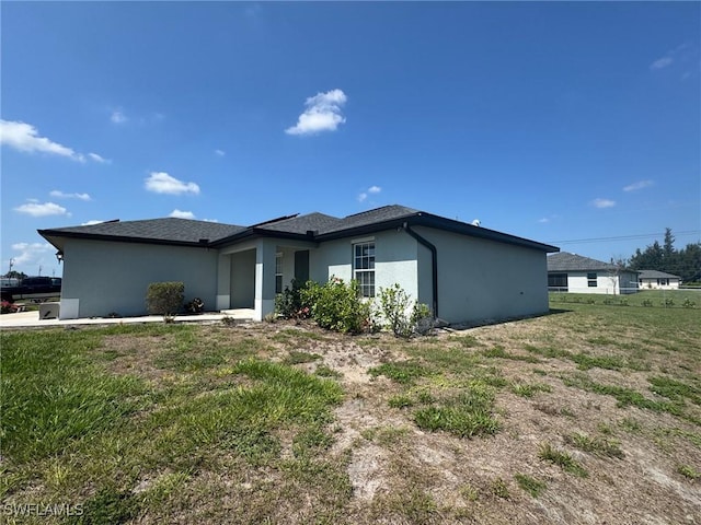 1818 NE 6th Pl, Cape Coral, FL 33909 - view of front of house with stucco siding and a front lawn