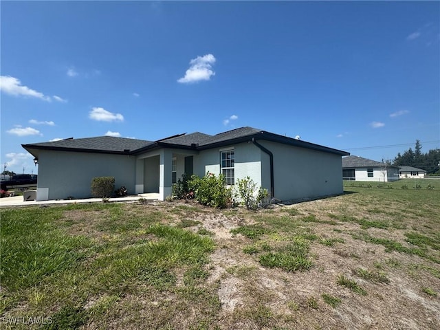 1818 NE 6th Pl, Cape Coral, FL 33909 - view of front facade featuring stucco siding and a front yard