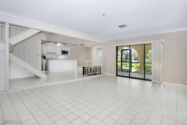 27910 Hacienda E Blvd Unit 201B, Bonita Springs, FL 34135 - unfurnished living room featuring baseboards, ornamental molding, and stairway