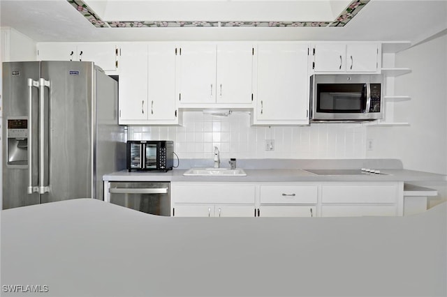 27910 Hacienda E Blvd Unit 201B, Bonita Springs, FL 34135 - kitchen with stainless steel appliances, a sink, white cabinets, open shelves, and light countertops