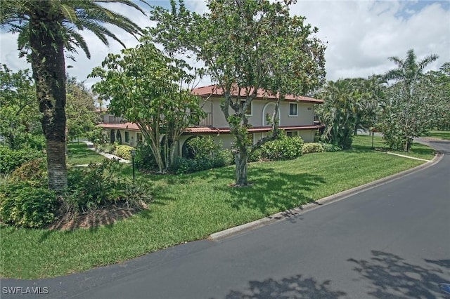 27910 Hacienda E Blvd Unit 201B, Bonita Springs, FL 34135 - obstructed view of property featuring a front yard and stucco siding