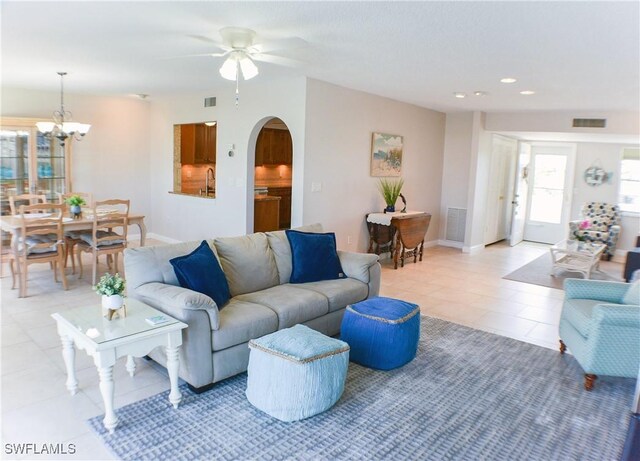 13511 Stratford Place Cir Unit 305, Fort Myers, FL 33919 - living room featuring arched walkways, light tile patterned flooring, recessed lighting, a ceiling fan, and a chandelier