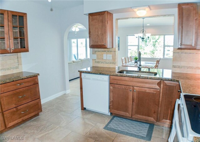 13511 Stratford Place Cir Unit 305, Fort Myers, FL 33919 - kitchen with white dishwasher, a sink, electric range oven, decorative backsplash, and stone countertops