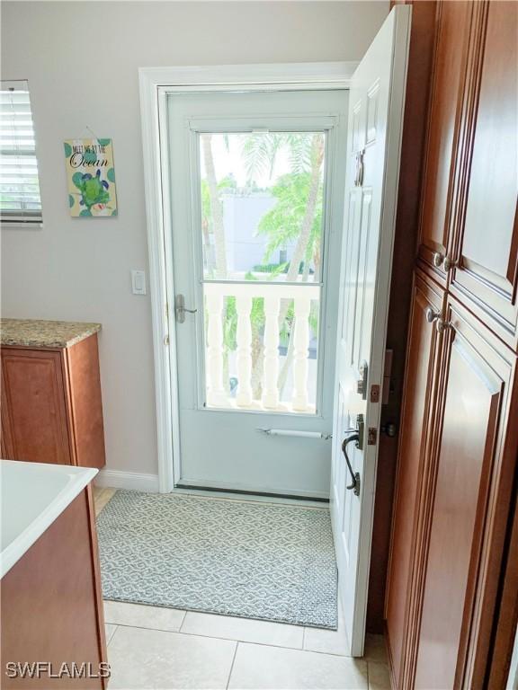 13511 Stratford Place Cir Unit 305, Fort Myers, FL 33919 - doorway to outside with light tile patterned flooring