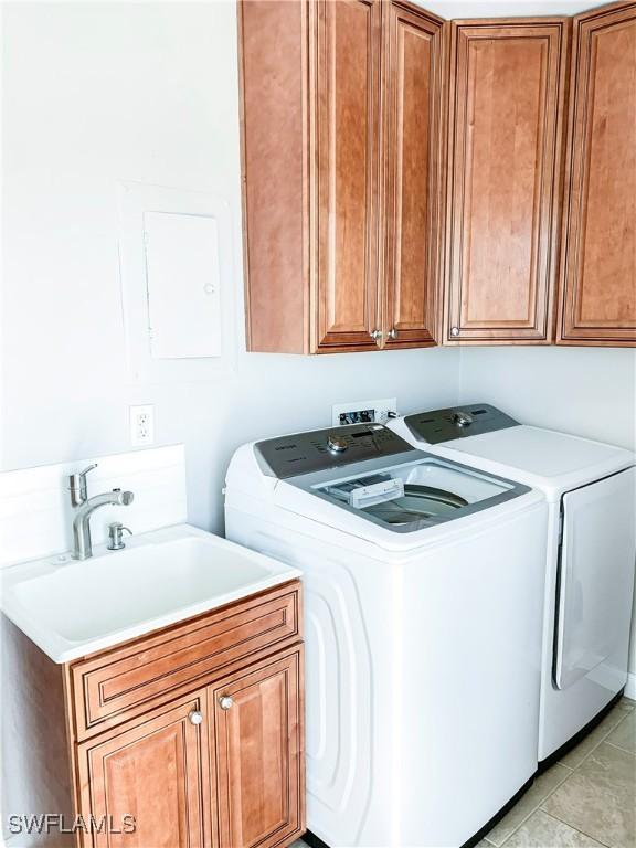 13511 Stratford Place Cir Unit 305, Fort Myers, FL 33919 - laundry room featuring washing machine and dryer and cabinet space