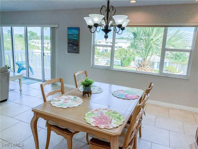 13511 Stratford Place Cir Unit 305, Fort Myers, FL 33919 - dining room featuring baseboards, a chandelier, and light tile patterned floors