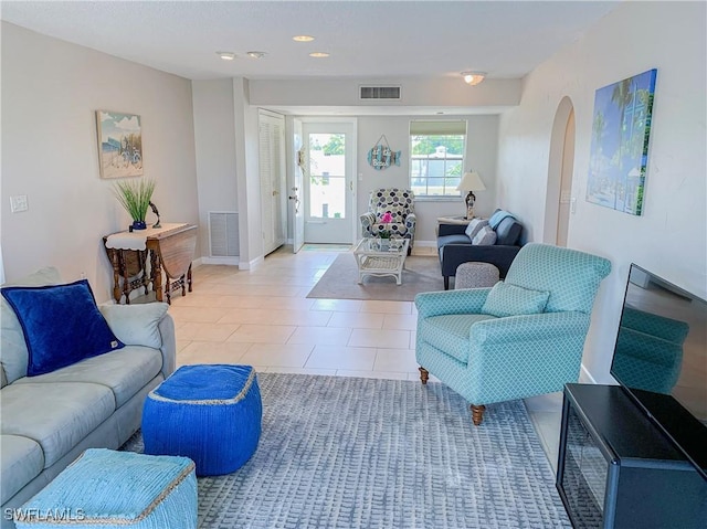 13511 Stratford Place Cir Unit 305, Fort Myers, FL 33919 - living room featuring arched walkways, light tile patterned floors, baseboards, and recessed lighting