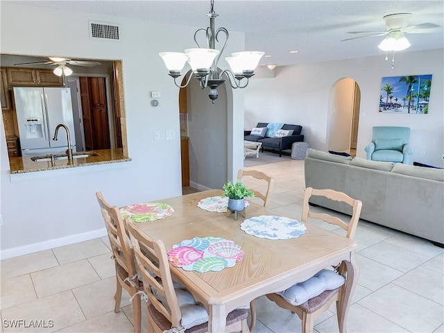 13511 Stratford Place Cir Unit 305, Fort Myers, FL 33919 - dining room with arched walkways, a ceiling fan, light tile patterned flooring, and a chandelier