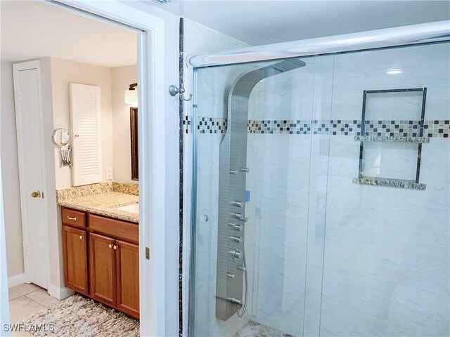 13511 Stratford Place Cir Unit 305, Fort Myers, FL 33919 - bathroom featuring a stall shower, vanity, and tile patterned floors