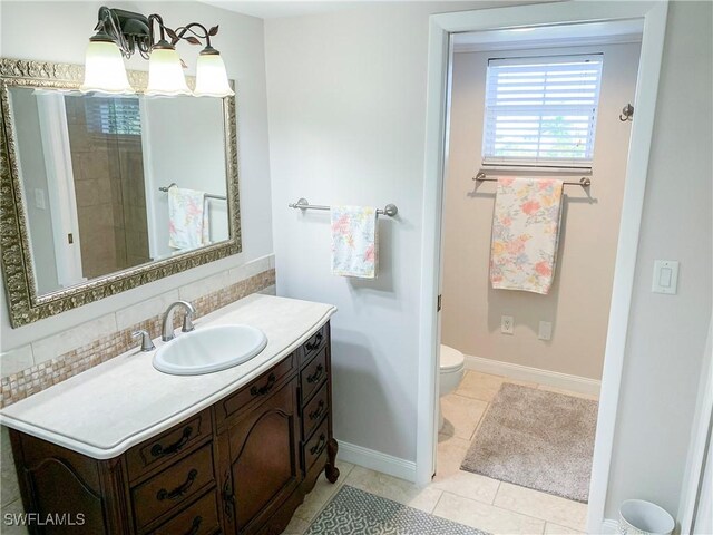 13511 Stratford Place Cir Unit 305, Fort Myers, FL 33919 - bathroom with vanity, backsplash, tile patterned flooring, toilet, and a chandelier