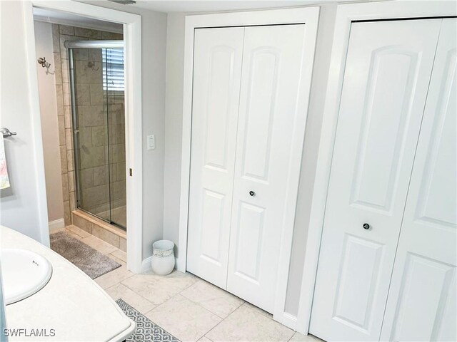 13511 Stratford Place Cir Unit 305, Fort Myers, FL 33919 - bathroom featuring a closet, a stall shower, baseboards, and vanity