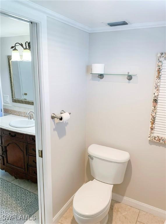 13511 Stratford Place Cir Unit 305, Fort Myers, FL 33919 - half bath with vanity, toilet, crown molding, and baseboards