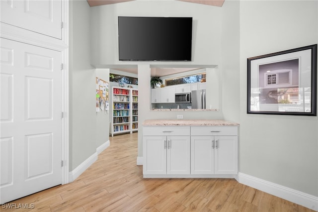 784 Carrick Bend Cir Unit 103, Naples, FL 34110 - bar with appliances with stainless steel finishes, baseboards, and light wood-style flooring