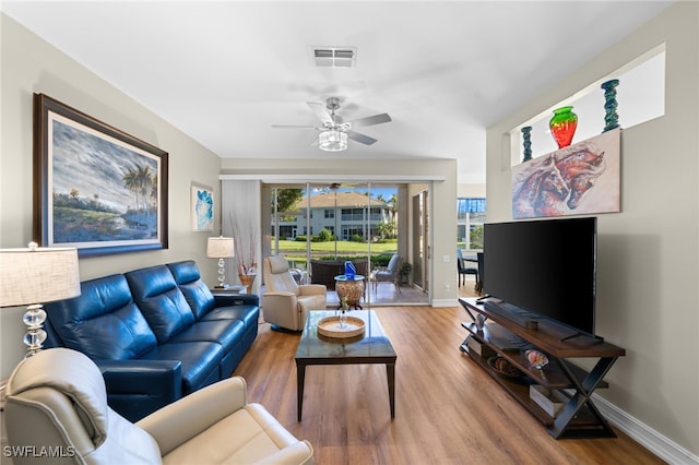 784 Carrick Bend Cir Unit 103, Naples, FL 34110 - living room featuring a ceiling fan, wood finished floors, and baseboards