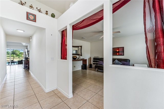 4665 47th Ave NE, Naples, FL 34120 - hallway with light tile patterned floors and baseboards