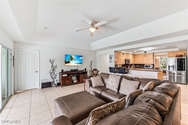 4665 47th Ave NE, Naples, FL 34120 - living room with a raised ceiling, light tile patterned floors, and a ceiling fan