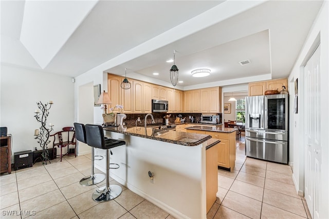4665 47th Ave NE, Naples, FL 34120 - kitchen featuring stainless steel appliances, light brown cabinetry, a tray ceiling, and recessed lighting