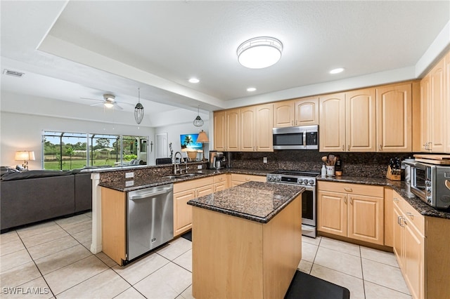 4665 47th Ave NE, Naples, FL 34120 - kitchen featuring appliances with stainless steel finishes, light brown cabinetry, a sink, a peninsula, and recessed lighting