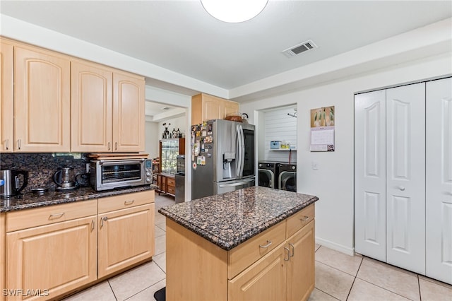 4665 47th Ave NE, Naples, FL 34120 - kitchen featuring light brown cabinetry, washer and dryer, stainless steel refrigerator with ice dispenser, and light tile patterned floors