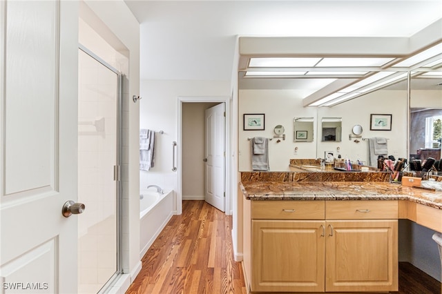 4665 47th Ave NE, Naples, FL 34120 - bathroom with a stall shower, wood finished floors, a garden tub, and vanity