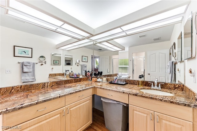 4665 47th Ave NE, Naples, FL 34120 - full bath featuring double vanity, a stall shower, and wood finished floors