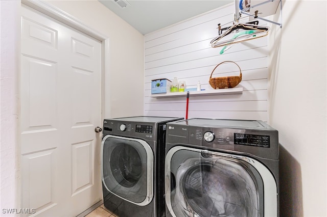 4665 47th Ave NE, Naples, FL 34120 - laundry area with separate washer and dryer and wood walls