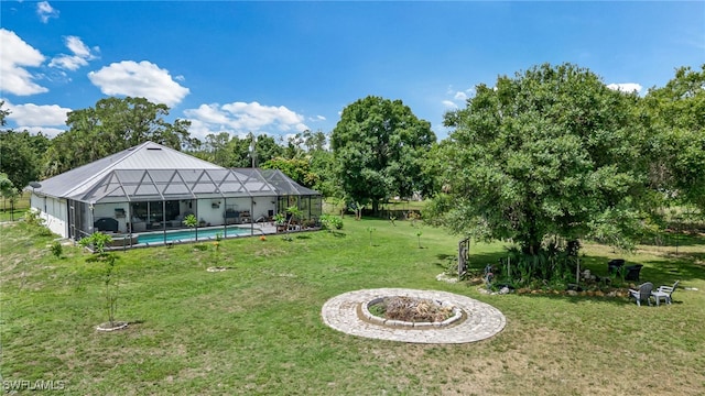 4665 47th Ave NE, Naples, FL 34120 - view of grassy yard with a lanai, an outdoor pool, and view of wooded area