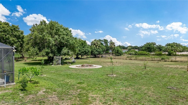 4665 47th Ave NE, Naples, FL 34120 - view of grassy yard featuring glass enclosure and a fire pit