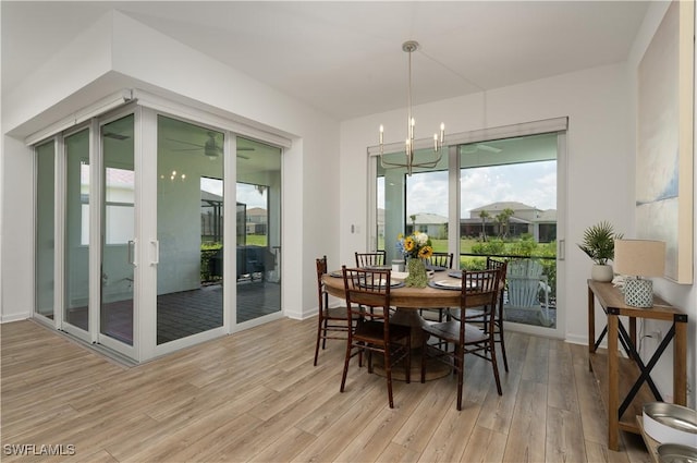42530 Atlas Dr, Punta Gorda, FL 33982 - dining area featuring light wood finished floors, a chandelier, and baseboards