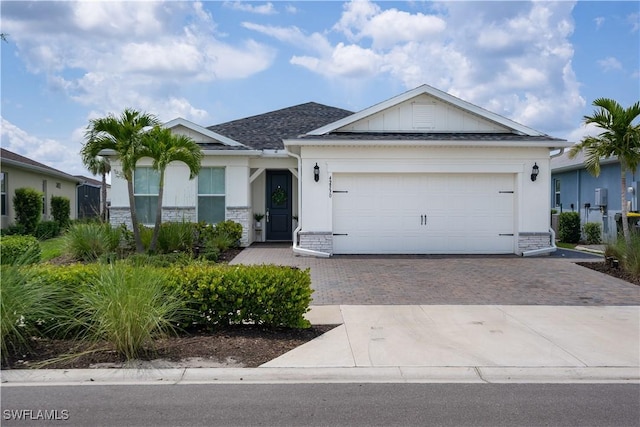 42530 Atlas Dr, Punta Gorda, FL 33982 - ranch-style home featuring decorative driveway, board and batten siding, and a garage