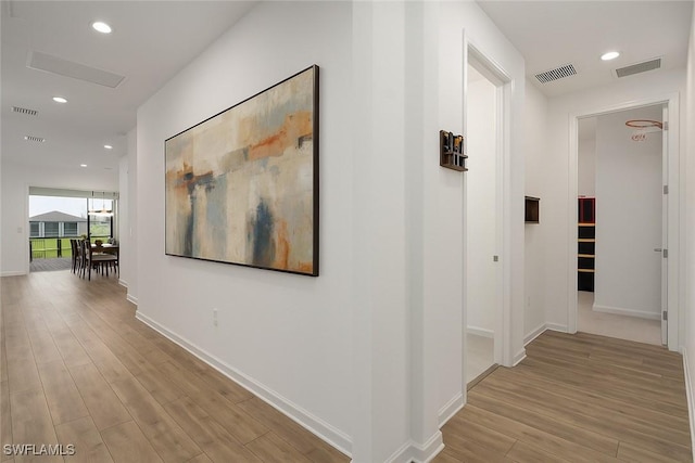 42530 Atlas Dr, Punta Gorda, FL 33982 - corridor featuring wood finished floors, recessed lighting, and baseboards