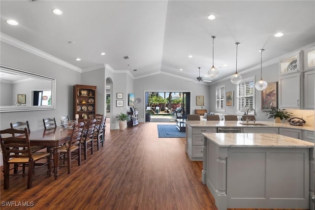 10340 Vanderbilt Dr, Naples, FL 34108 - kitchen with a sink, a peninsula, open floor plan, dark wood-style floors, and lofted ceiling