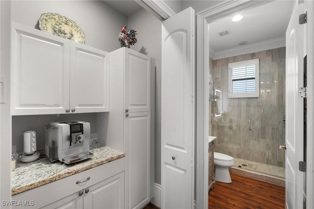 10340 Vanderbilt Dr, Naples, FL 34108 - bathroom featuring a shower stall, ornamental molding, toilet, wood finished floors, and vanity