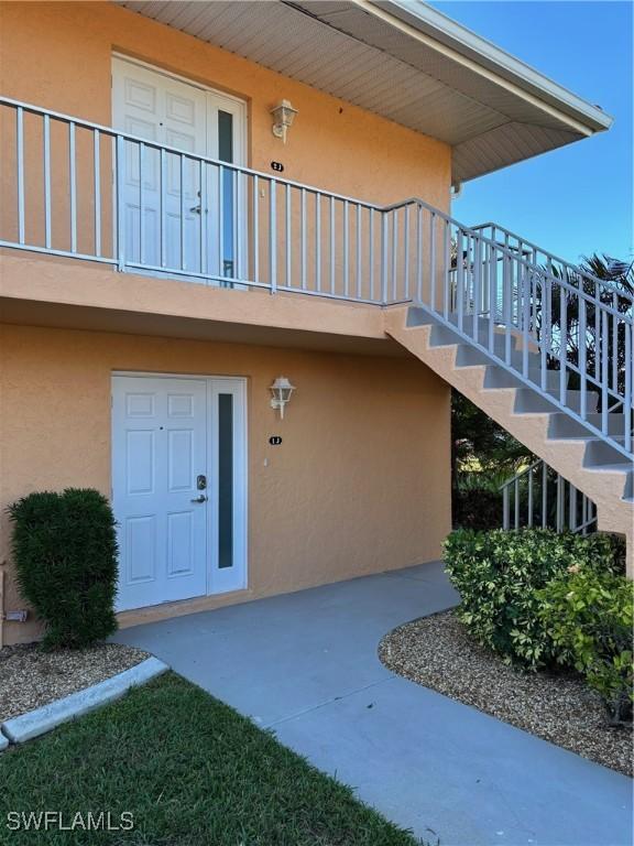 4210 SE 19th Ave Unit 2J, Cape Coral, FL 33904 - view of exterior entry featuring stucco siding