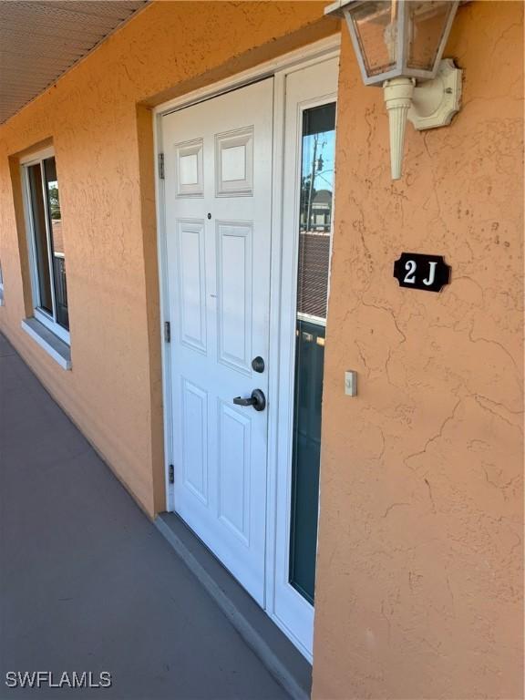 4210 SE 19th Ave Unit 2J, Cape Coral, FL 33904 - entrance to property with stucco siding