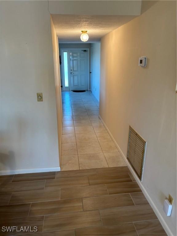 4210 SE 19th Ave Unit 2J, Cape Coral, FL 33904 - corridor with baseboards and wood tiled floors