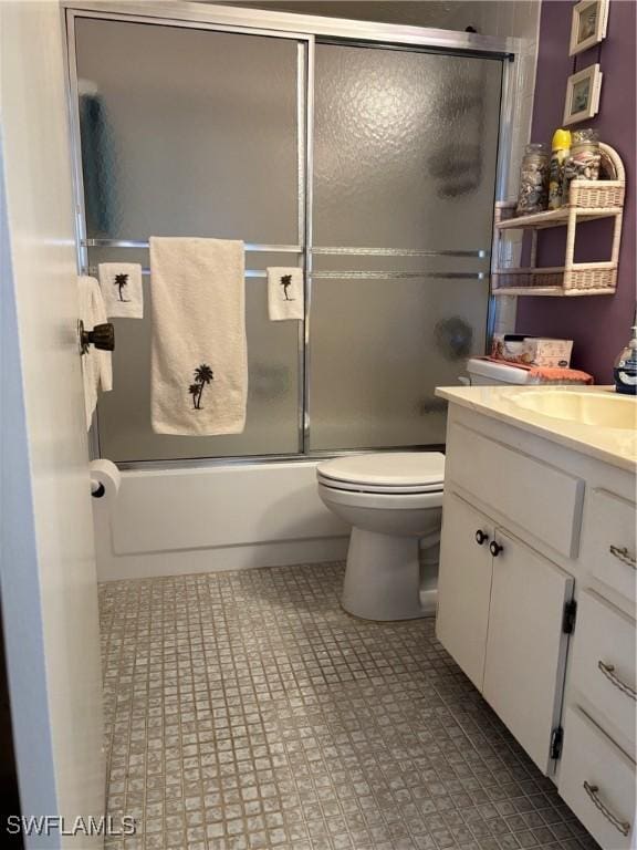 4210 SE 19th Ave Unit 2J, Cape Coral, FL 33904 - bathroom featuring vanity, bath / shower combo with glass door, and toilet