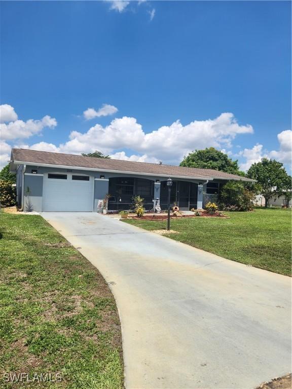210 Highview Ave, Lehigh Acres, FL 33936 - single story home featuring a garage, concrete driveway, and a front lawn