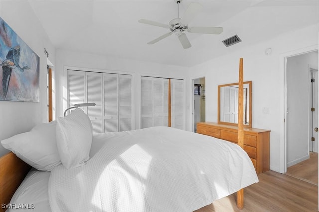 3627 Clipper Ln, Saint James City, FL 33956 - bedroom with multiple closets, light wood-type flooring, and ceiling fan