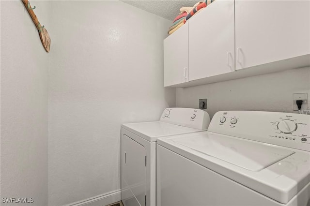 1044 Woodshire Ln Unit B102, Naples, FL 34105 - laundry area with washer and clothes dryer, cabinet space, and a textured ceiling