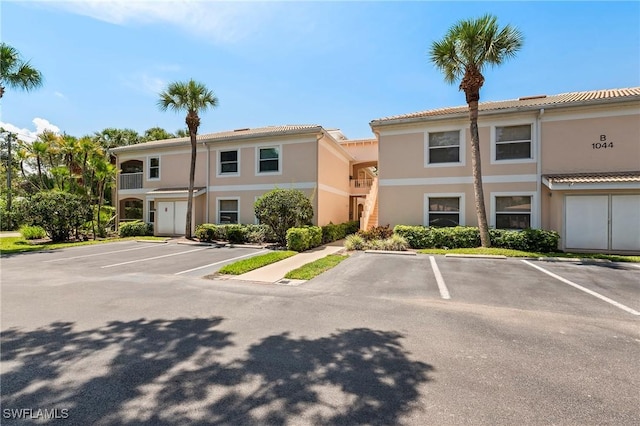 1044 Woodshire Ln Unit B102, Naples, FL 34105 - view of building exterior with uncovered parking