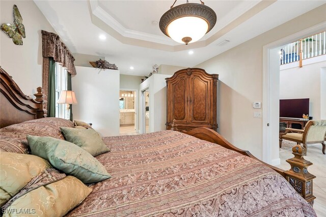 28686 San Galgano Way, Bonita Springs, FL 34135 - bedroom with recessed lighting, a tray ceiling, ornamental molding, and connected bathroom