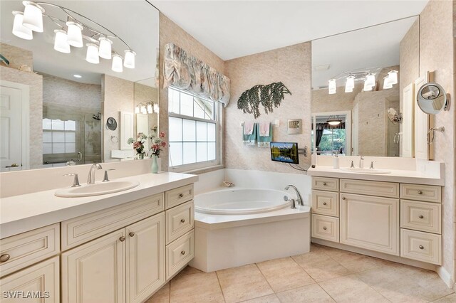 28686 San Galgano Way, Bonita Springs, FL 34135 - bathroom with a stall shower, two vanities, a garden tub, and tile patterned flooring