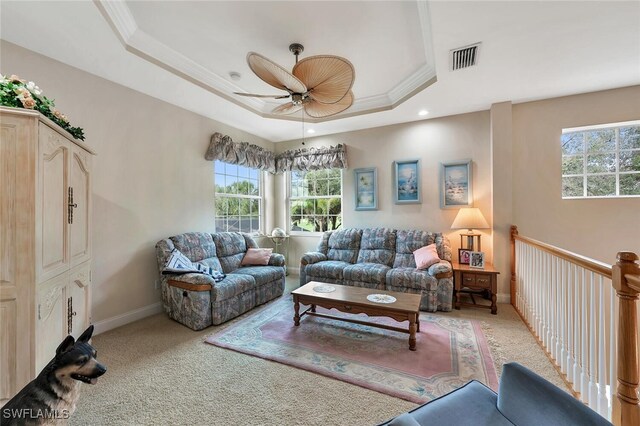 28686 San Galgano Way, Bonita Springs, FL 34135 - living room with a tray ceiling, plenty of natural light, a ceiling fan, light colored carpet, and crown molding