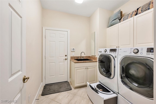 28686 San Galgano Way, Bonita Springs, FL 34135 - laundry area with separate washer and dryer, cabinet space, light tile patterned floors, and baseboards